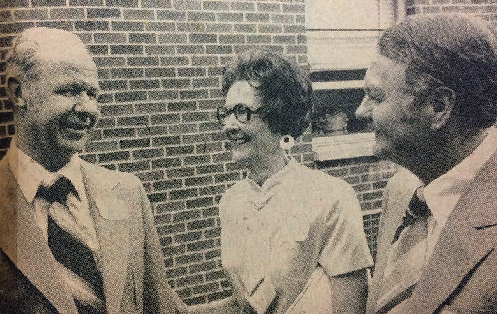 Black and white photograph that appeared in the Alexandria Gazette newspaper on May 25, 1978. The photograph shows three individuals, William Jack Burkholder, Rose S. Rogers, and Joseph B. Hucks, standing outside Rose Hill Elementary School.