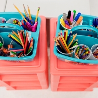 crayons and pencils in a storage container